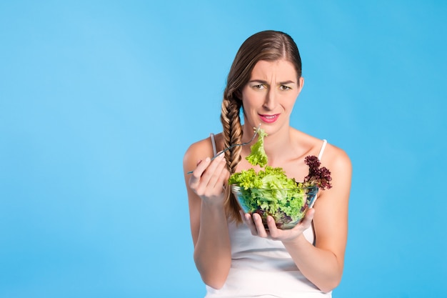 Healthy nutrition - young woman with salad