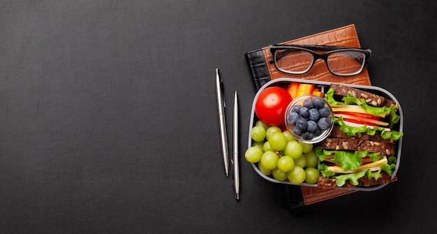 Premium Photo | Healthy office lunch box with sandwich and fresh vegetables