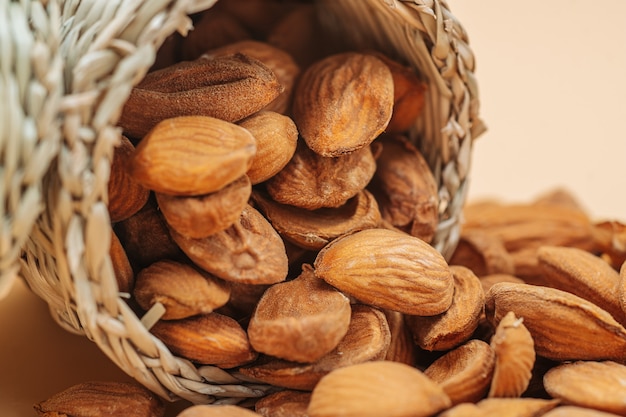 Healthy organic dried almonds in a straw basket