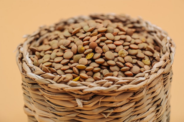 Healthy organic dried lentils in a straw basket