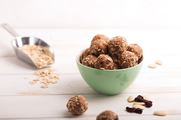 Healthy organic energy granola bolls with nuts, cacao, oats and raisins - vegetarian sweet bites without sugar