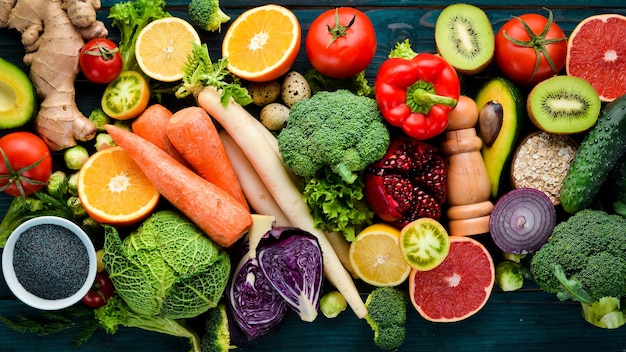 Photo healthy organic food on a blue wooden background vegetables and fruits top view free copy space