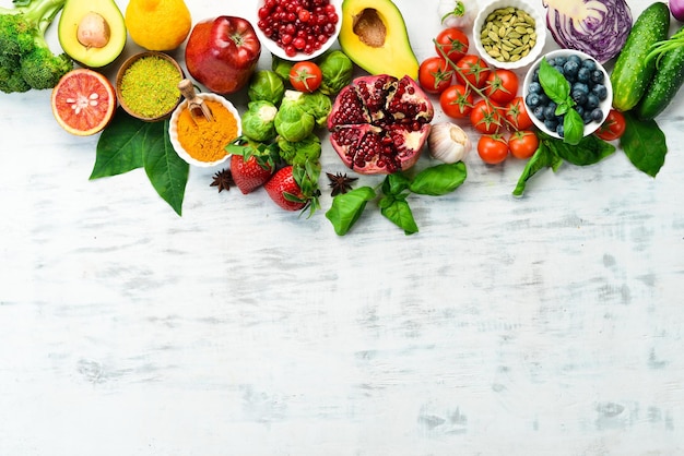 Healthy organic food fresh vegetables and fruits on a white wooden background Free space for your text