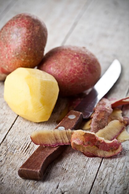 Healthy organic peeled potatoes and knife 