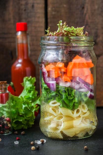 healthy pasta vegetable salad in a jar