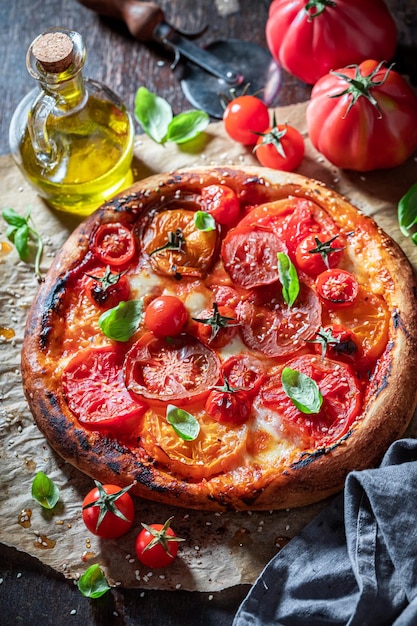 Healthy pizza Margherita served with olive oil and sesame