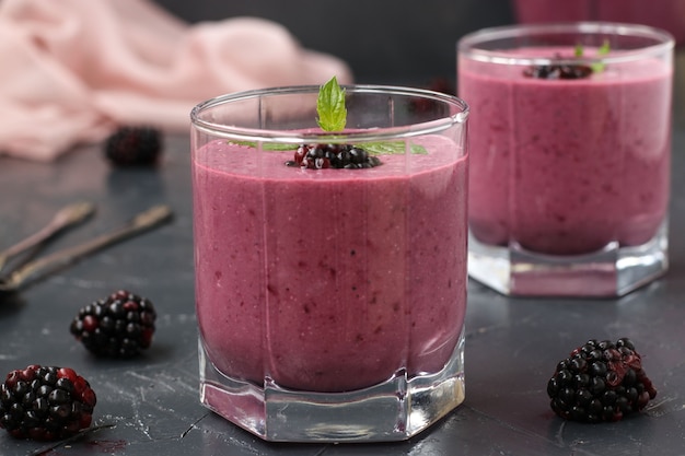 Healthy protein cocktail with cottage cheese and blackberries on dark background