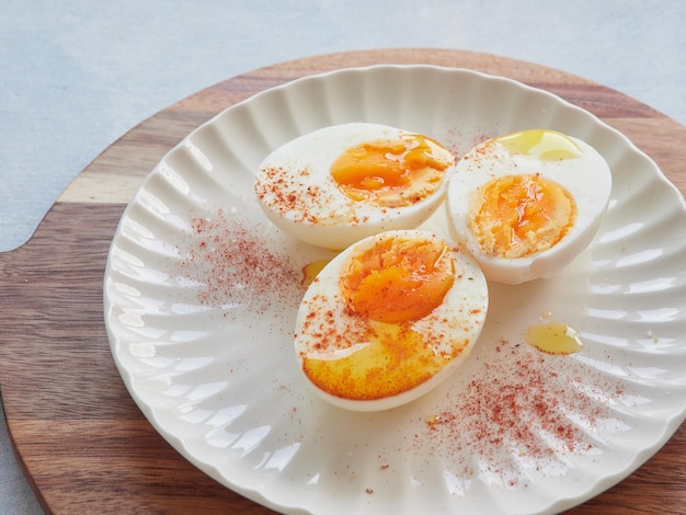 Healthy and protein food Hard boiled eggs with olive oil and paprika on top