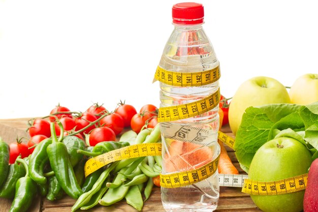 Healthy raw food with water on wooden table