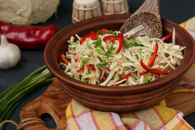 Healthy salad from cabbage and sweet pepper in a brown salad bowl