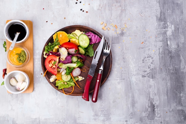 Healthy salad plate with vegetables on stone background p. Food and health. Clean eating.