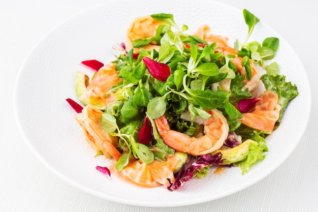 Healthy Salad. Recipe for fresh seafood. Grilled shrimps, prawns, fresh salad lettuce and avocado slices.