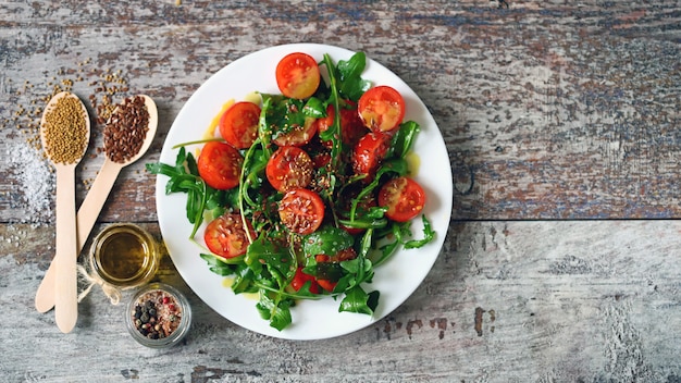 Healthy salad with arugula and cherry tomatoes with mustard sauce