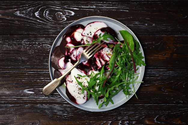 Healthy salad with beets and arugula with yogurt dressing Vegan style food