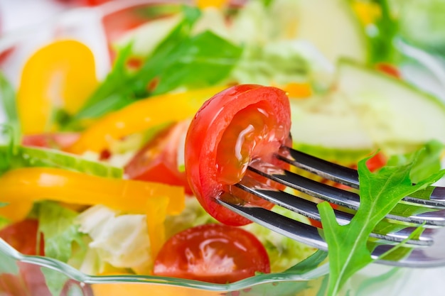 Healthy salad with fresh vegetables in a glass bowl