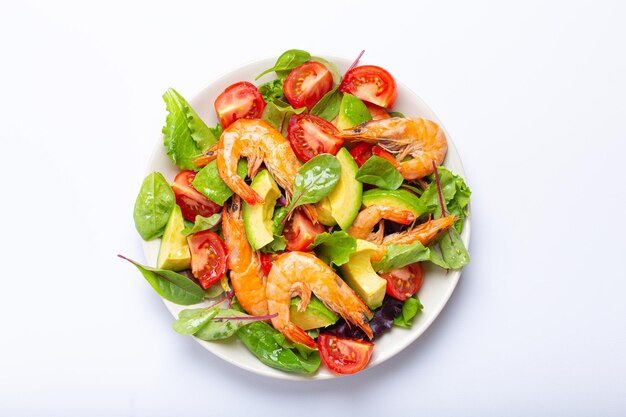 Healthy salad with grilled shrimps avocado cherry tomatoes