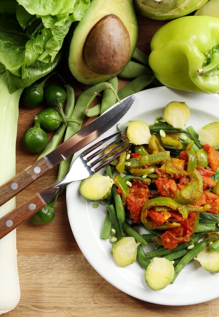 Photo healthy salad with peas and asparagus served on wooden table closeup