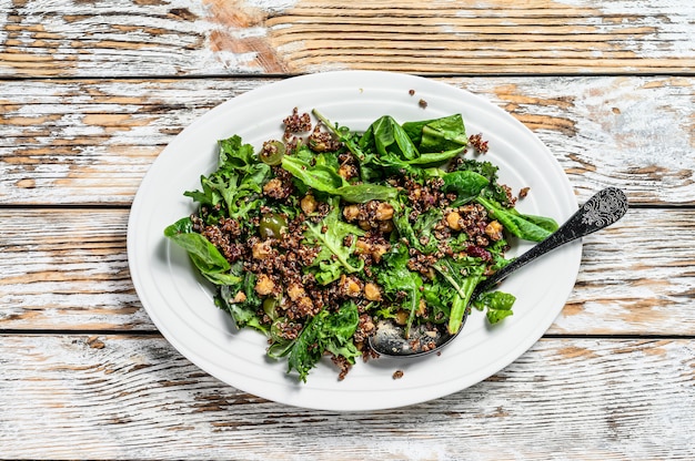 Healthy salad with spinach,quinoa and roasted vegetables. Super food on white. Top view