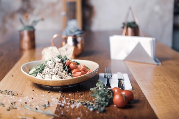 Healthy salad with walnut and cheese in the bowl