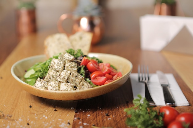 Healthy salad with walnut and cheese in the bowl