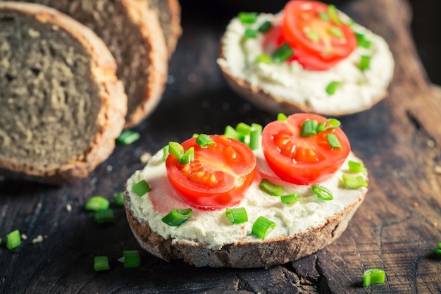 Healthy sandwich with fromage cheese cherry tomatoes and chive