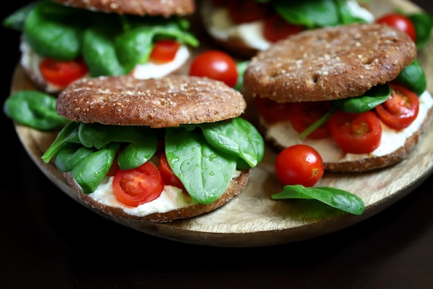 Healthy sandwiches with spinach cherry tomatoes and white cheese Useful snack Keto diet