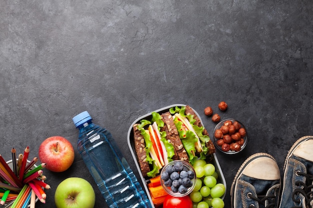 Healthy school lunch box with sandwich and fresh vegetables