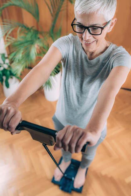 Healthy Senior Woman Measuring Body Fat with Body Composition Monitor