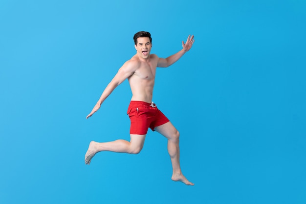 Healthy shirtless handsome caucasian man in summer short pants jumping