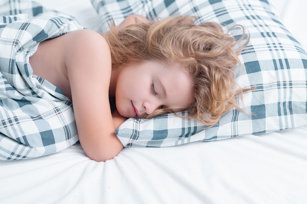 Healthy sleep kid sleeping in bed child sleeping under blanket lying on pillow child rest asleep enj