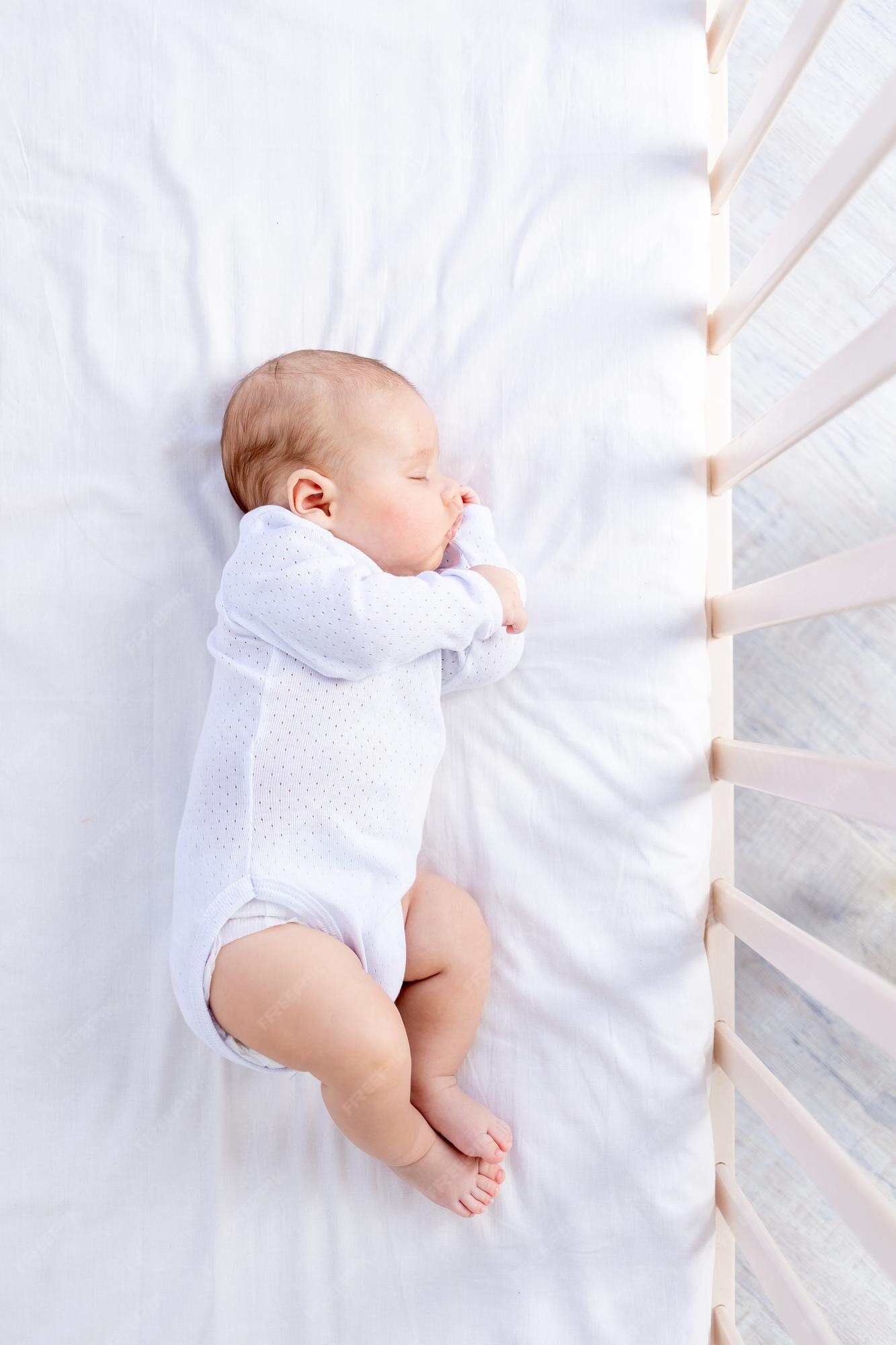 Premium Photo Healthy sleep of a newborn baby in a cot in a bedroom