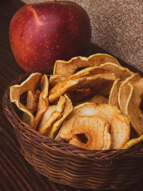 Healthy snack Homemade dehydrated apple chips on rustic wooden background