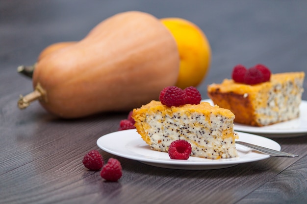 Healthy snack. Pumpkin homemade cheesecake or cake with raspberries, poppy, orange. 