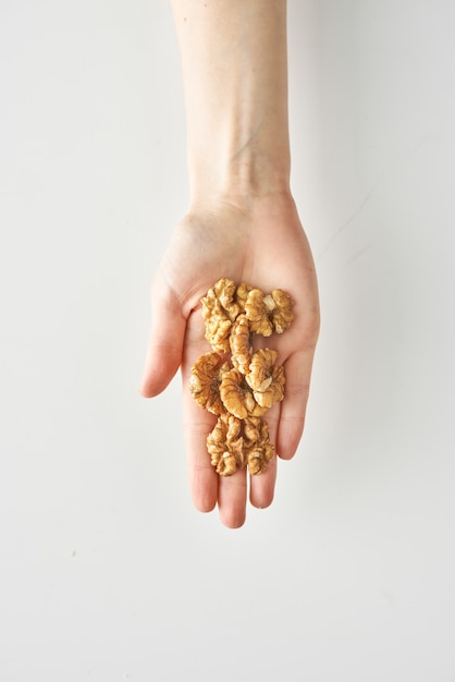 Healthy snack of walnuts in hand isolated