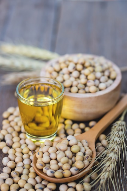 Healthy soybean on wooden floor, wooden cup, wooden spoon together as a group, copy space