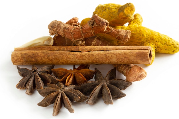 Healthy spices on a white background Turmeric ginger garlic star anise cinnamon sticks