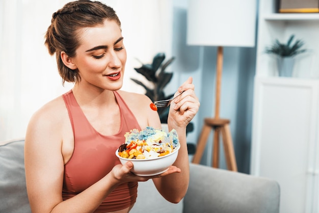 Healthy sporty and vegetarian couple in sportswear with vegan at gaiety home