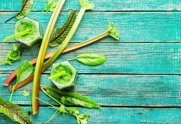 Healthy summer green smoothie from stalks of rhubarb and herbs.Copy space