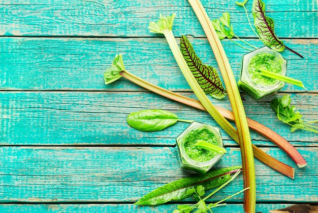 Healthy summer green smoothie from stalks of rhubarb and herbs.Copy space