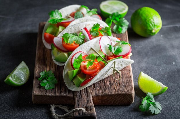 Healthy tacos made of tomatoes avocado and hebrs