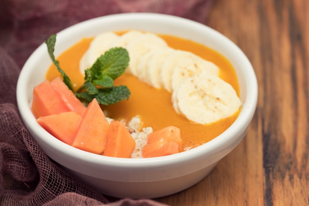 Healthy and tasty breakfast with mango in white bowl