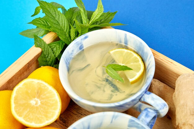 Healthy tea two cups with lemon, ginger, mint