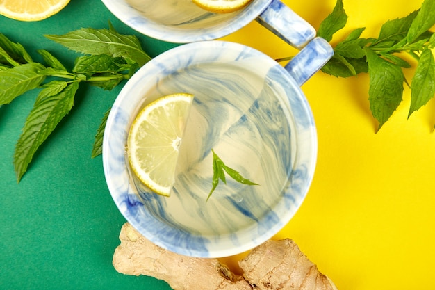 Healthy tea two cups with lemon, ginger, mint