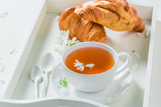 Healthy tea with honey in sunny summer day