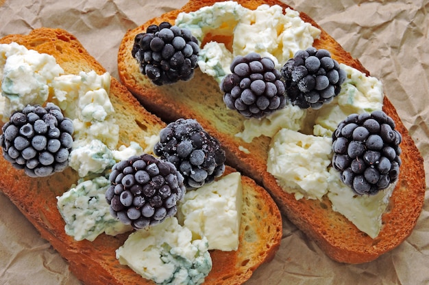 Healthy toasts with cream cheese and blackberries. Cheese berry toasts. Keto snack.