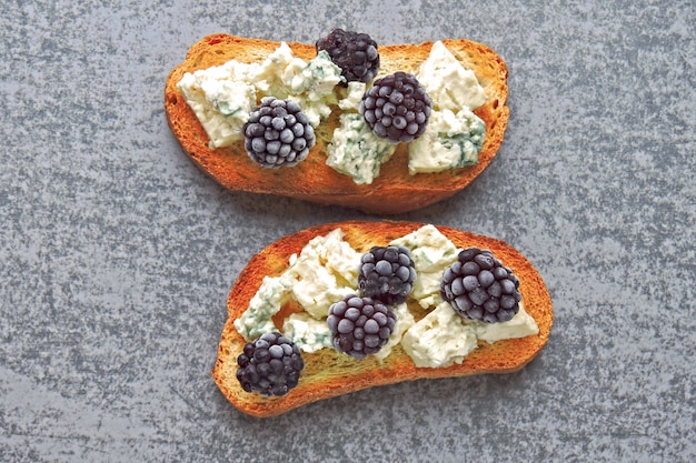 Healthy toasts with cream cheese and blackberries. Cheese berry toasts. Keto snack.