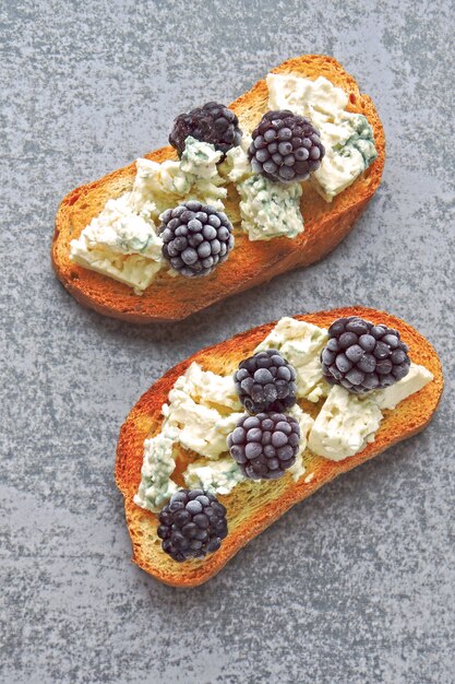 Healthy toasts with cream cheese and blackberries. Cheese berry toasts. Keto snack.