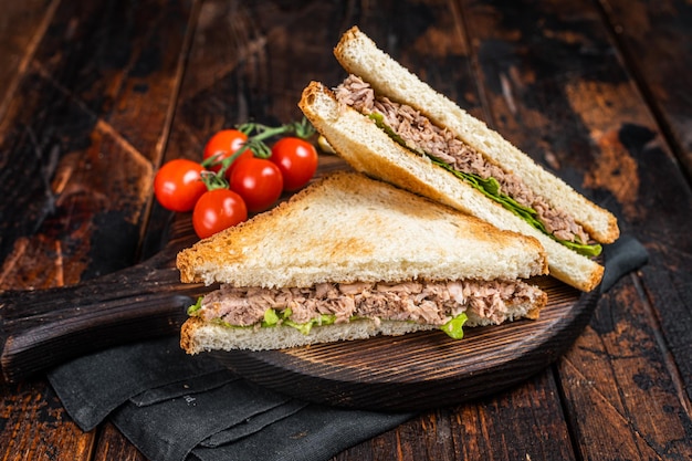 Healthy Tuna Sandwich with Lettuce on wooden board Dark background Top view