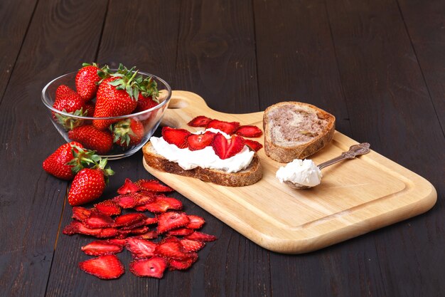 Healthy useful snack with strawberry chips and homemade cheese