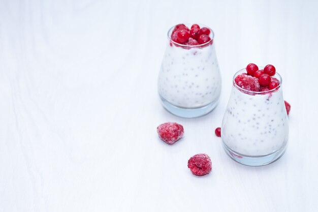 Healthy vanilla chia pudding with red berries. Healthy snack concept. Copy space.